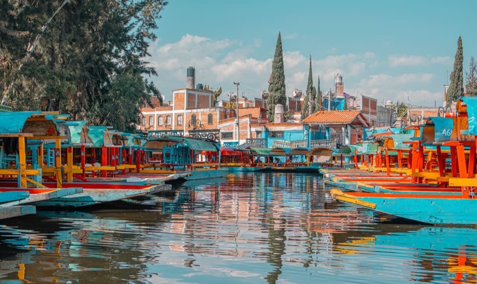 Colorful canal boats in Mexico, from Shea's travels with Wayfinder